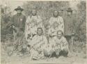 Four native American men and two men in Western dress posing for photograph; One wears a six pointed star