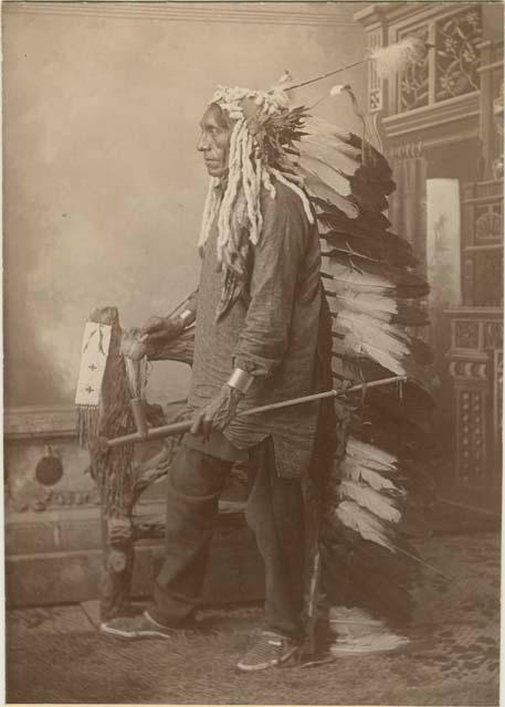 Circling Bear dressed in War Bonnet; Posed studio portrait