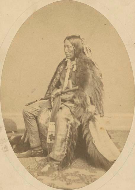 Dual shaped studio portrait of seated man holding pipe