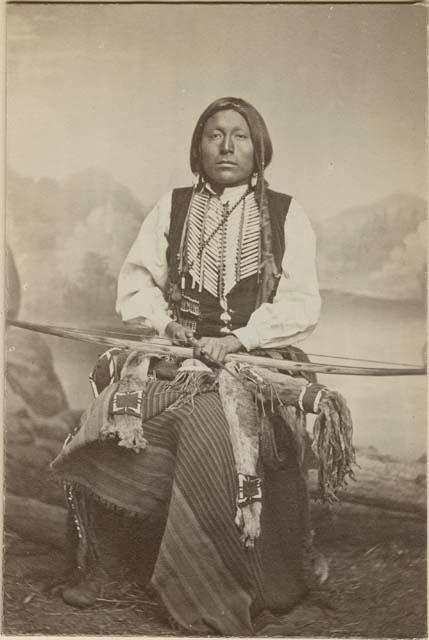 Full-length studio portrait of man, seated