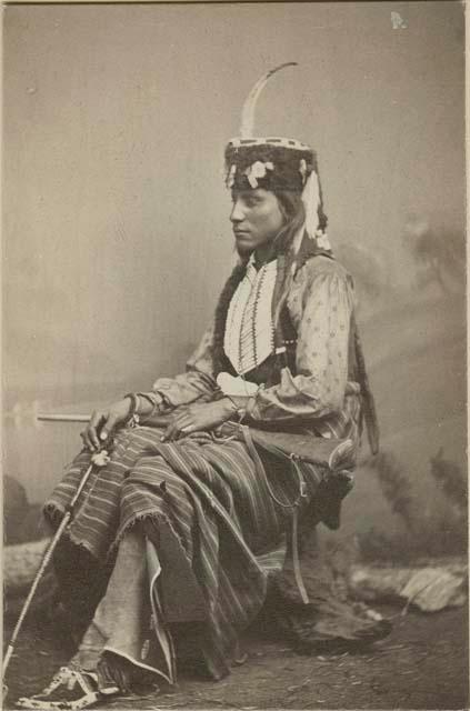 Full-length studio portrait of Lone Wolf's son, seated