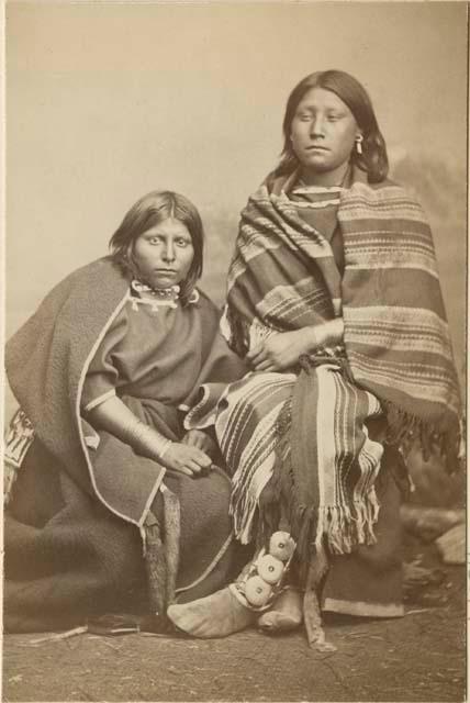 Full-length studio portrait of two woman