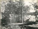 man standing near campfire