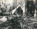 man standing in A-frame tent