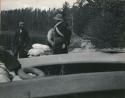 boats on shore and men around