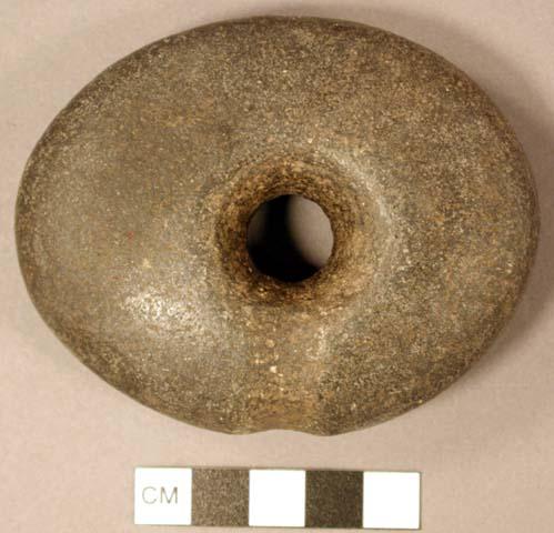 Ground stone object, perforated, possible net sinker.