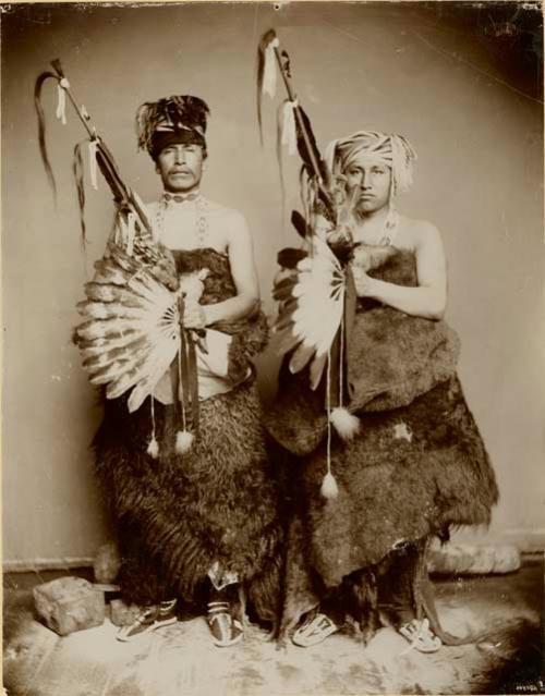 Two men holding Omaha sacred pipes of Fellowship