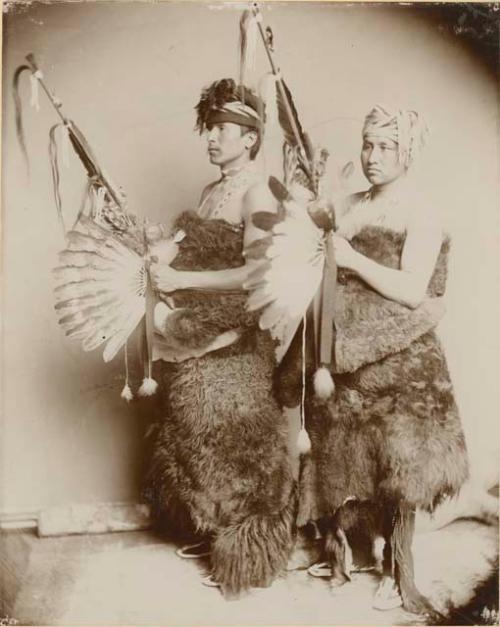 Posed studio portrait, full-length, two men, standing and holding pipes