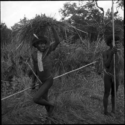 Warriors holding bunches of grass