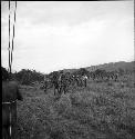 A group of men carry a wounded young warrior to safety