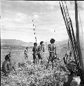 Aloro and other men watch the action down in the hollow of the elbow of the Warabara