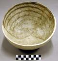 Black-on-white pottery bowl, restored