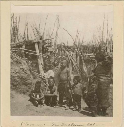 Children and women outside a dwelling