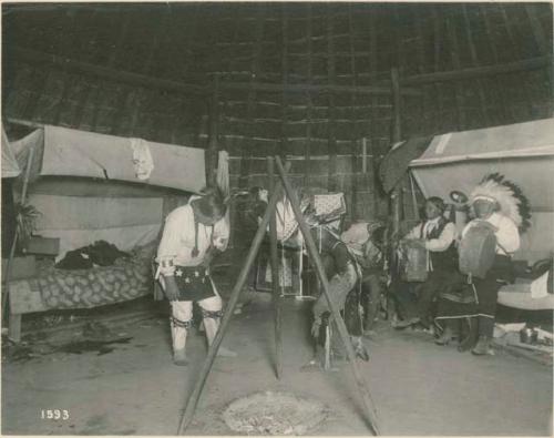 Flashlight of Wichita Indian war dance in the grass lodge at St. Louis