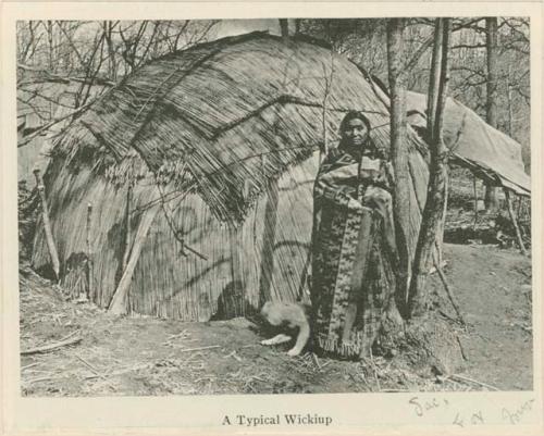 Woman standing in front of a wickiup