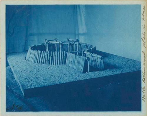 Model of an earth lodge, made by Miss Gay, with cotton wood slabs in place