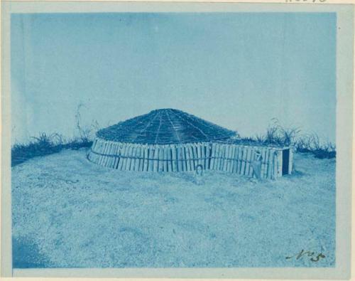 Model of an Earth Lodge, made by Miss Gay, with cotton wood slabs in place