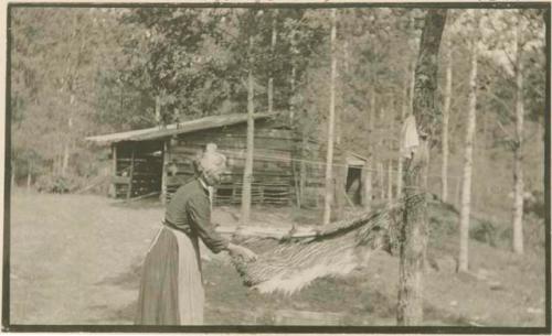 Woman scraping off hair of skin Keshena