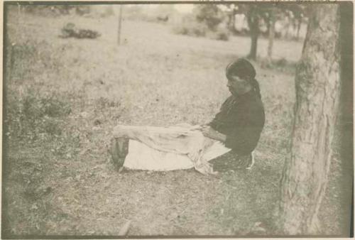 Menominee Indian stretching skin in tanning.