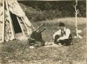 Mary Ann Morris and Peter Deny playing waltes tag'n, a Micmac bow and dice game
