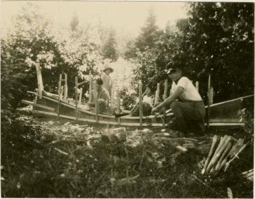 Basil Partridge making a canoe