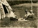 Mr. and Mrs. Christopher Morris playing the waltes'tagɣn, a Micmac bowl and dice game