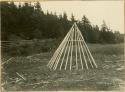 Stages in building Micmac wigwam; Addition of light poles to foundation frame and hoop
