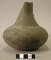 Ceramic vessel, long neck, broken at rim, grooved around neck base, crack along