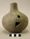 Ceramic vessel, long neck, broken at rim, mended, sherds missing from body