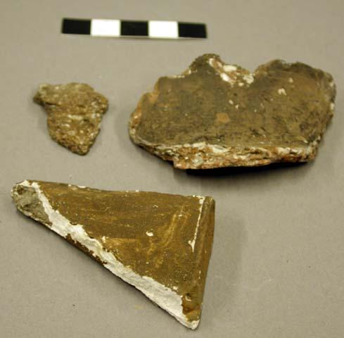 2 ceramic, earthenware sherds, 1 body sherd and 1 incised rim sherd, shell-temepred, 1 plaster rim sherd with small portion of attached earthenware