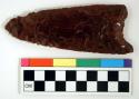 Chipped implement; chipped from red and black mottled obsidian