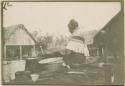 Woman sifting corn at Little Billy's camp.