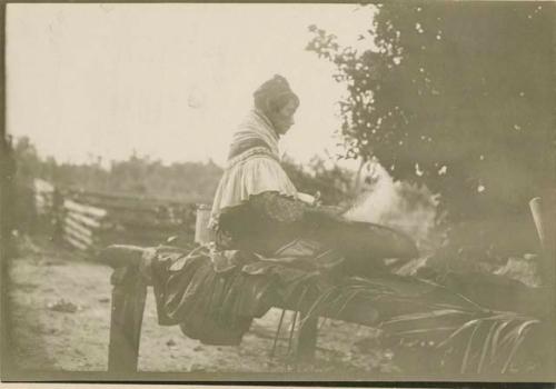 Woman winnowing corn