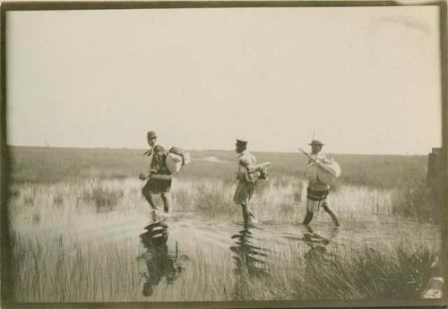 Seminoles travelling on foot (unusual) through Everglades