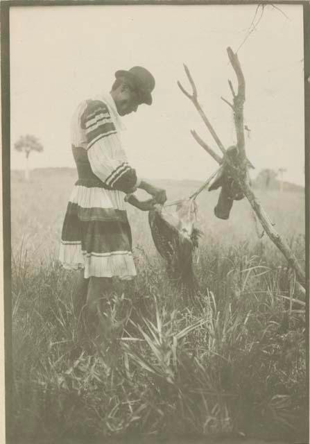 Wilson Cypress skinning a wild turkey (not plucked) near Okalowe Kutci Slough