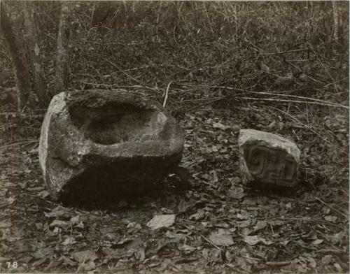 water trough (mortar?) and sculptured stone near wall