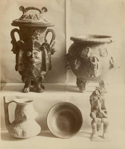 various ceramic vessels including an effigy pot with a human face