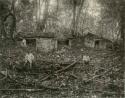 Two men in front of ruins at Chicozapote