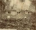 Two men in front of ruins at El Chicozapote