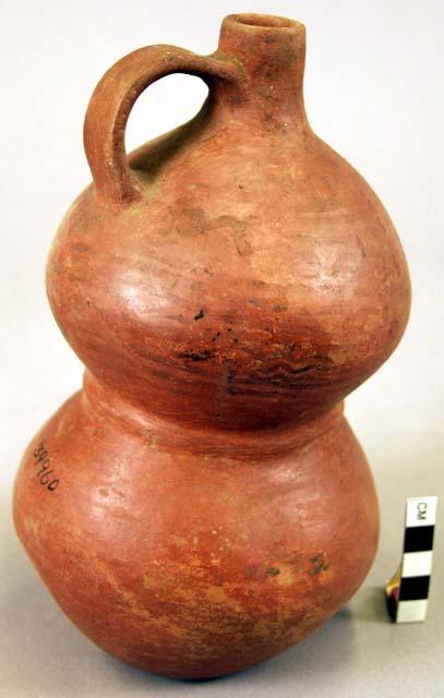 Pottery jar, handle on side, constricted in center, red