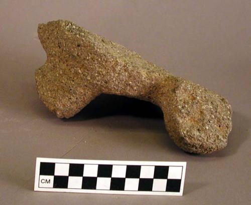 Foot of stone metate made in shape of head of serpent