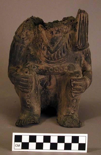 Ceramic, seated, effigy, head missing, incised design, 7 perforations