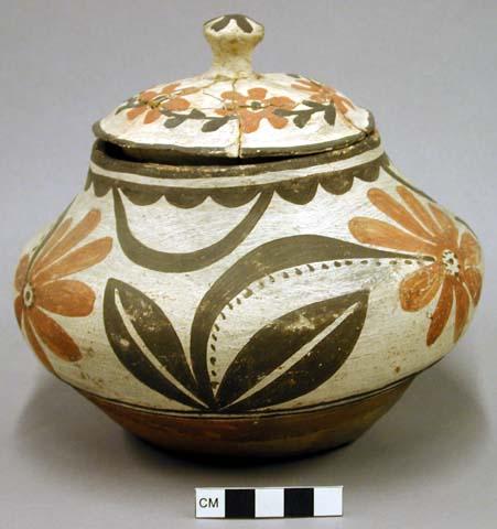 Pottery jar with cover. Floral decoration, red and black on white.