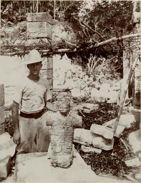 Man standing beside a stone figure at Great Mound