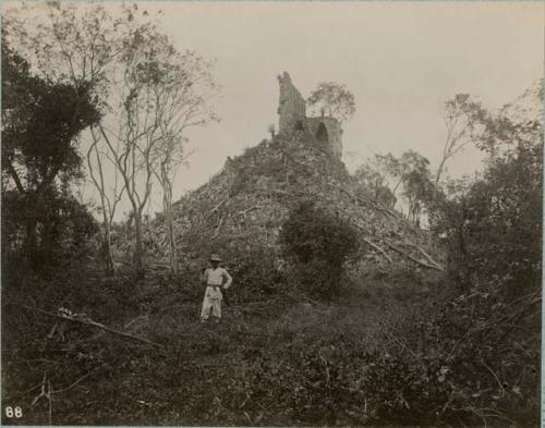 Man standing in front of temple ruin