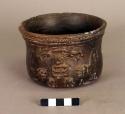 Earthen cup. black pottery, human figure