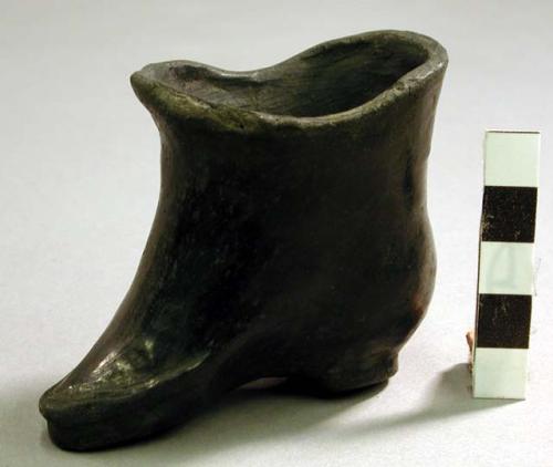 Pottery jar. Black ware, shoe-shaped.