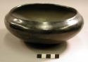 Pottery bowl. Round with recurved rim, shallow, highly polished black ware, und