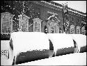 Snow on large concrete pipes in front of Fogg Museum