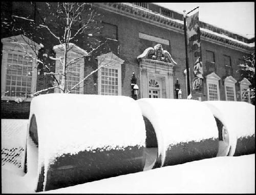 Snow on large concrete pipes in front of Fogg Museum